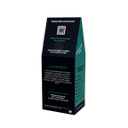 A tall, black coffee bag package with teal side panels and white text, photographed on a plain white background. The front reads 'CATUA NOVO' and includes descriptive coffee blend text and a QR code near the top.