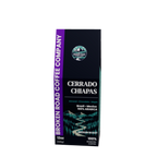 A 12oz box of Broken Road Coffee Company Cerrado Chiapas coffee, featuring a dark green and black design with a purple side banner and a scenic mountain illustration.