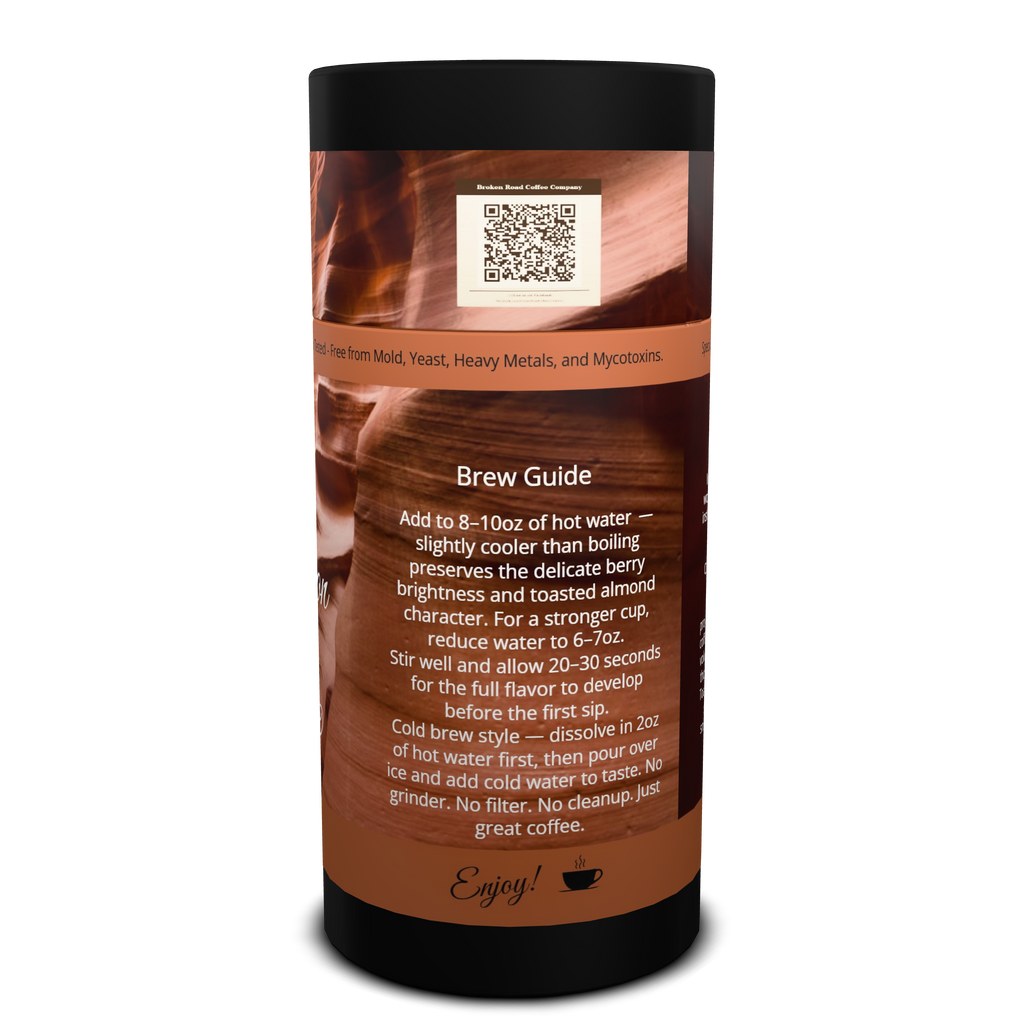 A cylindrical coffee bean canister with a black top and bottom and a brown label featuring a grand canyon red rock graphic, a QR code, and a 'Brew Guide' text section on a white background.