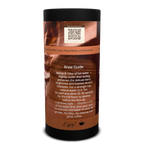A cylindrical coffee bean canister with a black top and bottom and a brown label featuring a grand canyon red rock graphic, a QR code, and a 'Brew Guide' text section on a white background.