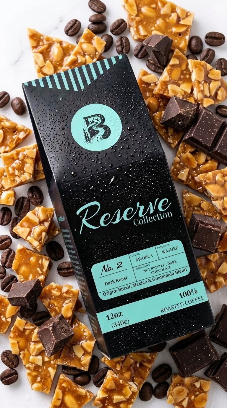 A bag of Reserve Collection No. 2 dark roast coffee is displayed diagonally on a white marble background, surrounded by decorative chocolate pieces, caramel corn, and coffee beans.